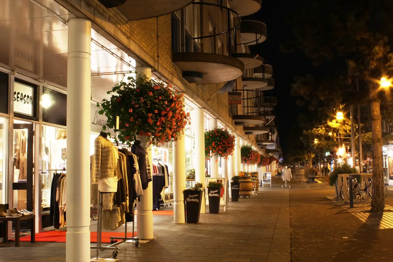 Outdoor view of a shopping center with bright LED lighting enhancing the storefronts and walkway